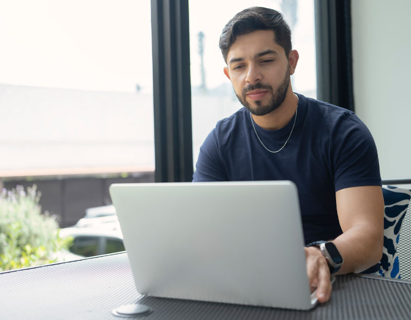 young man working on laptop at home