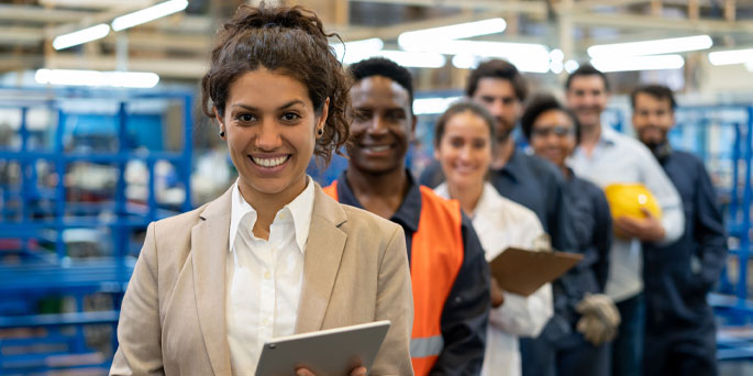 Female factory manager with team