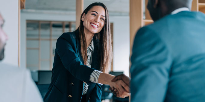 young professionals in office shaking hands