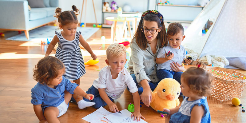 Young female with toddlers in home care environment